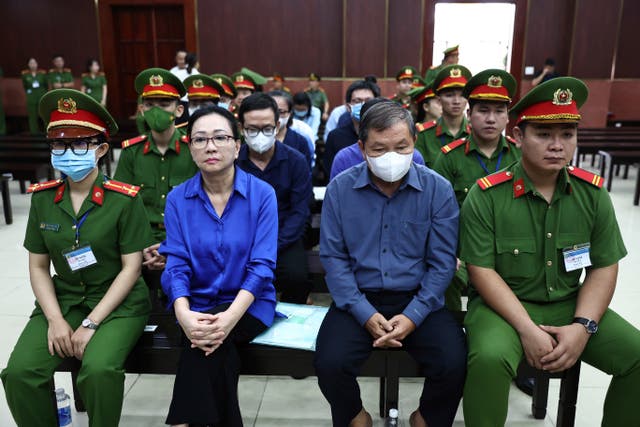 Truong My Lan, second left, attends trial in an appeal she filed against her death sentence in a financial fraud case in Ho Chi Minh City, Vietnam