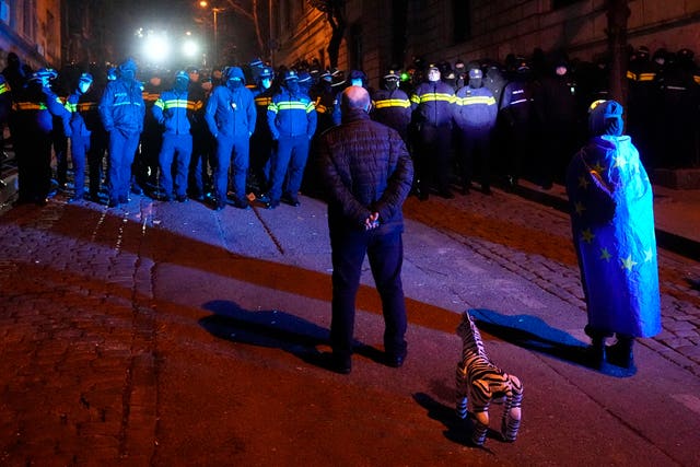 Police block demonstrators during a rally outside the parliament 