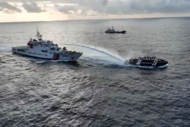 The Chinese vessel fires a water cannon