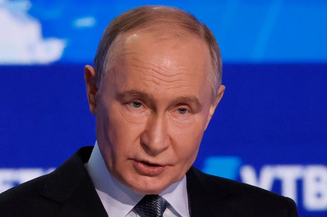 Headshot of Vladimir Putin with a blue background