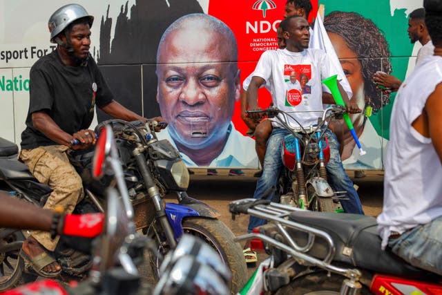 Supporters of former Ghanaian president and candidate for the National Democratic Congress, John Mahama, ride motorbikes on a street