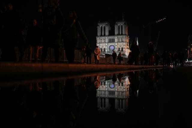 Notre Dame cathedral is reflected in a puddle in Paris