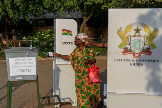 A woman casts her ballot in the general elections in Accra