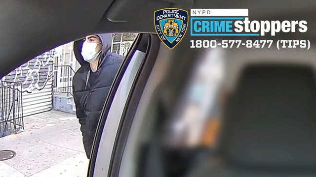 Man in facemask outside a taxi