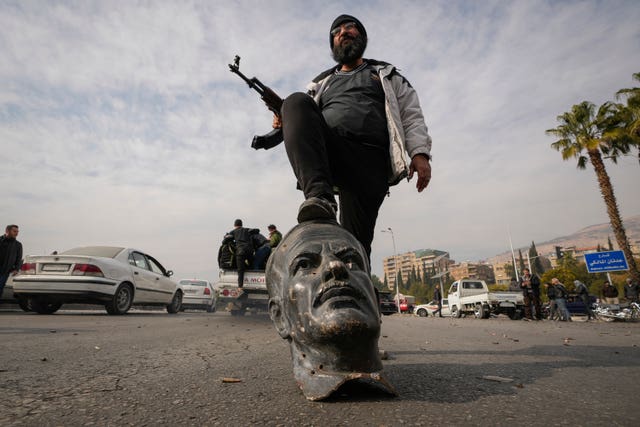 Man on foot of statue head