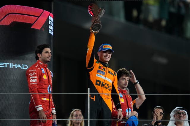 Lando Norris celebrates on the podium