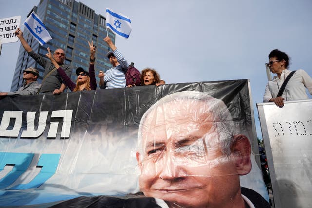 Supporters carry a huge poster showing Netanyahu's face