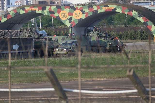 Taiwan army ground force members ride on vehicles at an airbase in Hsinchu, northern Taiwan