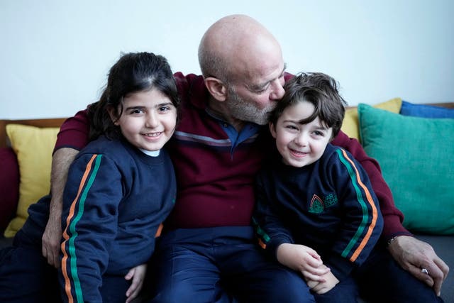 The freed man hugs his grandchildren