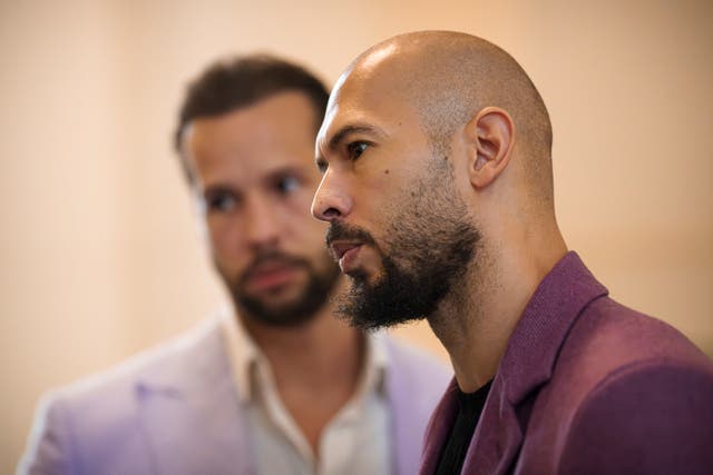 Andrew Tate, right, stands next to his brother Tristan, left, at the Court of Appeals building in Bucharest, Romania