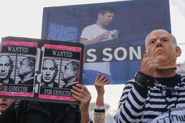 A protester wearing a Netanyahu mask outside his trial in Tel Aviv