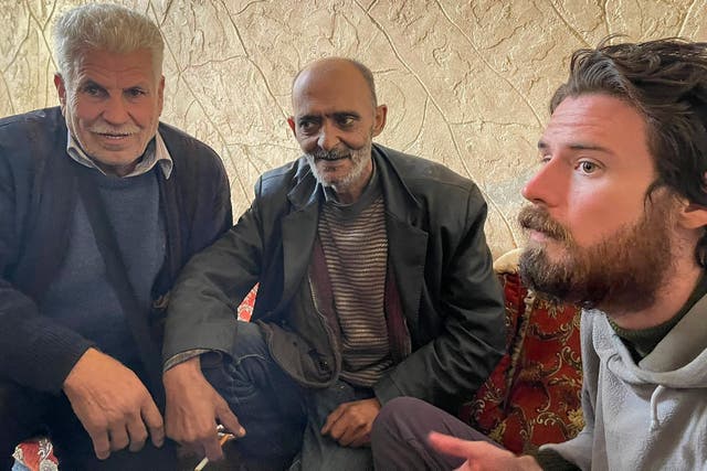 Travis Timmerman with two men in a house where he took refuge