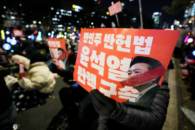 Participants hold banners during a rally to demand South Korean President Yoon Suk Yeol’s impeachment