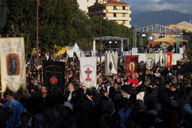 Members of catholic local brotherhoods arrive for Mass in Ajaccio 