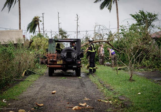 Soldiers and rescue workers clearing a street in the French territory of Mayotte in the Indian Ocean after Cyclone Chido 