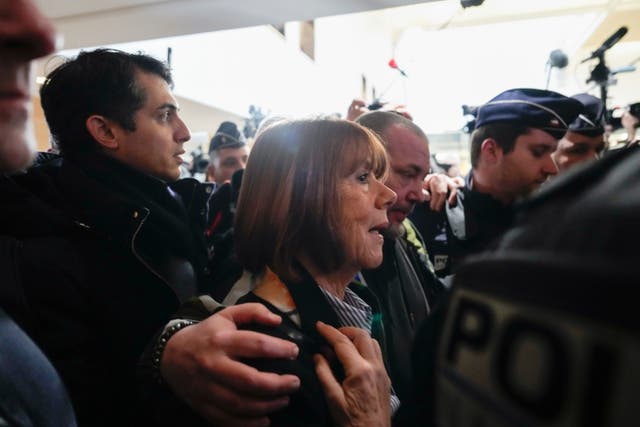 Gisele Pelicot is surrounded as she arrives at court