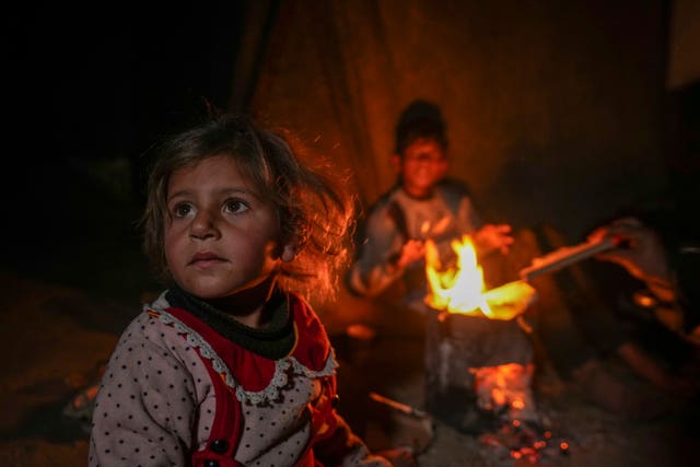 Young girl near a camp fire