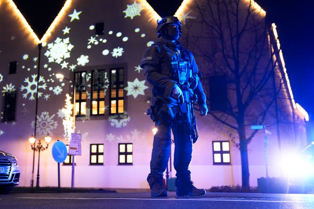 A police officer guards a cordoned-off area of the market in Magdeburg