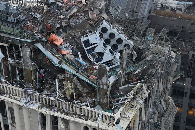 Firefighters work on the site of a damaged building 