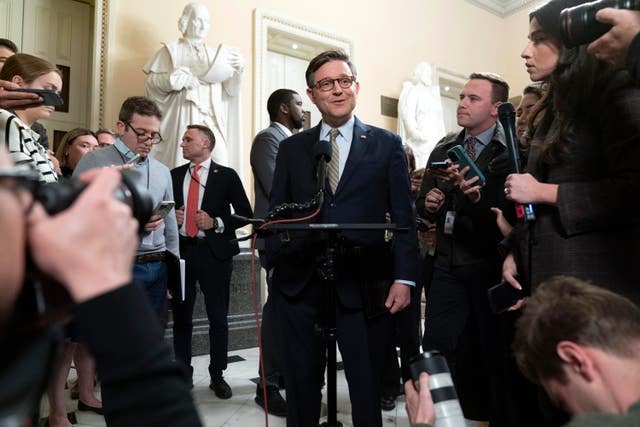 Speaker of the House Mike Johnson talks to reporters after the House approved the funding bill