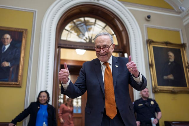 Chuck Schumer celebrating by holding two thumbs up as the Senate begins voting on the government funding bill just in time to meet the midnight deadline