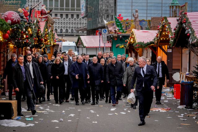 German Chancellor Olaf Scholz, centre, at the scene of the tragedy in Magdeburg