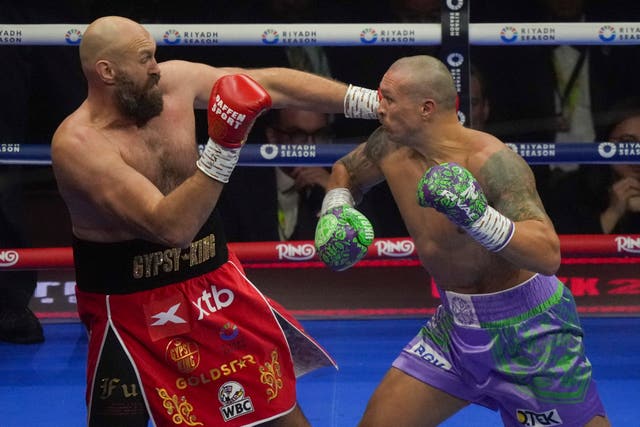 Britain’s Tyson Fury, left, and Ukraine’s Oleksandr Usyk in action