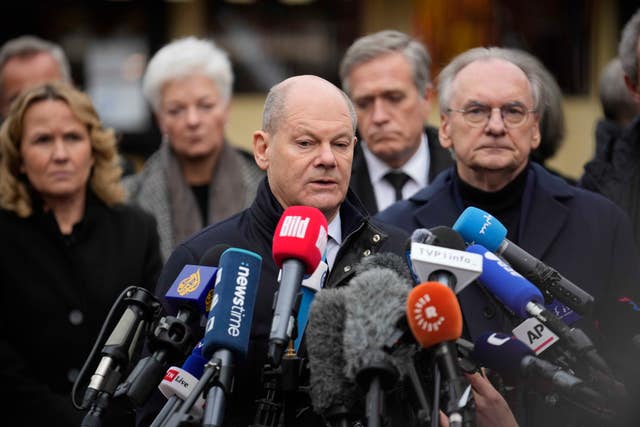 Germany's Chancellor Olaf Scholz talking to reporters at the Christmas market in Magdeburg on Saturday