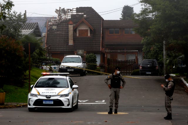 Police cordon off houses that were hit by a plane in Gramado, Rio Grande do Sul State, Brazil