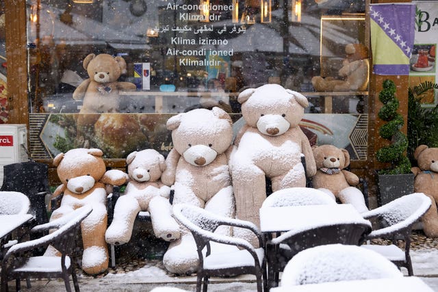 Teddy bears covered with snow outside a cafe in Sarajevo, Bosnia