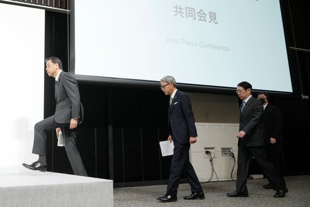 Nissan chief executive Makoto Uchida, left, and Honda chief Toshihiro Mibe, centre, and Takao Kato, head of Mitsubishi Motors, arrive to attend a joint news conference in Tokyo