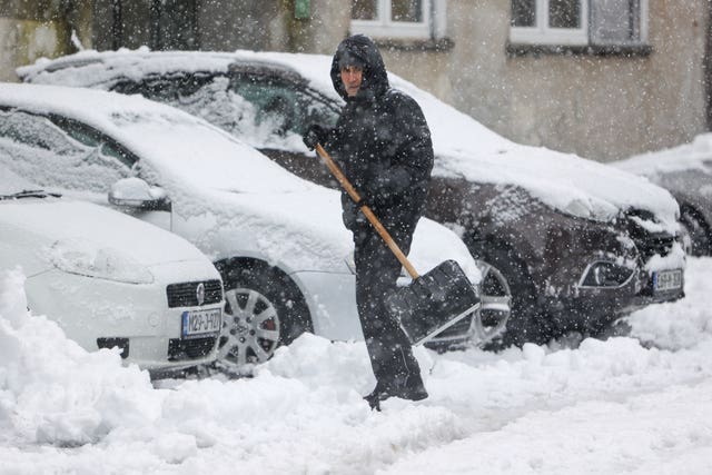 A man shovels snow from the street in Bihac, Bosnia 