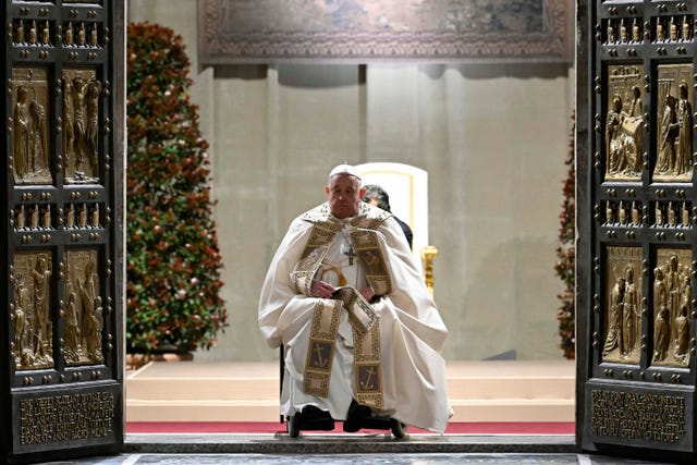 Pope Francis opens the holy door marking the start of the Catholic jubilar year 2025 before presiding over the Christmas Eve Mass in St Peter’s Basilica at the Vatican