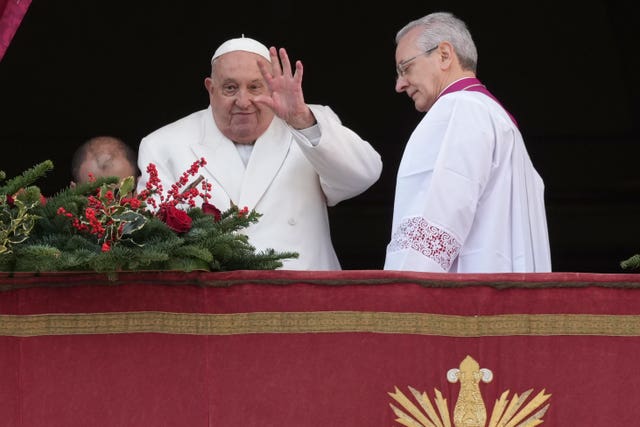 Pope Francis waves before delivering the Urbi et Orbi (Latin for ‘to the city and to the world’ ) Christmas Day blessing from the main balcony of St Peter’s Basilica at the Vatican