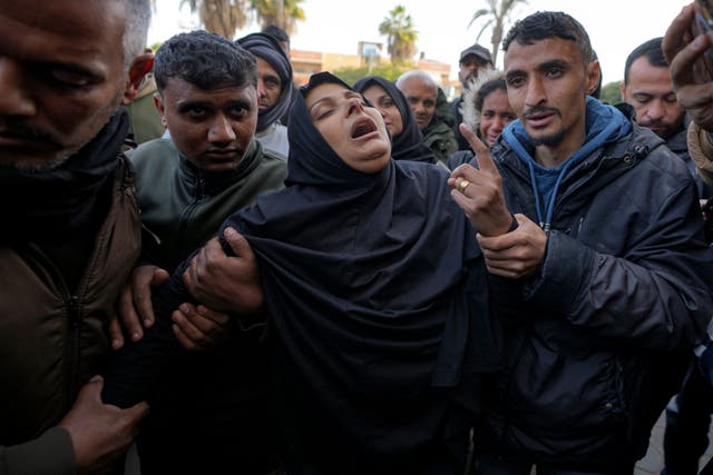 Mourners carry the bodies of five Palestinian journalists