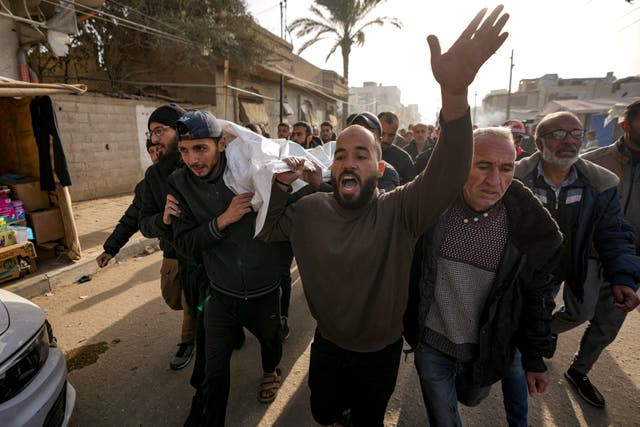 Mourners carry the bodies of five Palestinian journalists