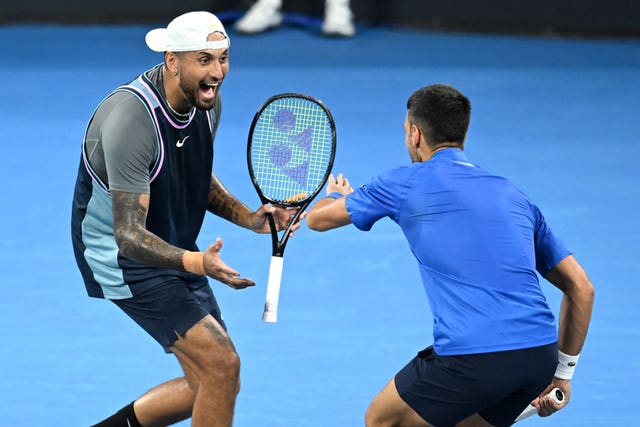 Nick Kyrgios, left, and Novak Djokovic celebrate winning a point in doubles