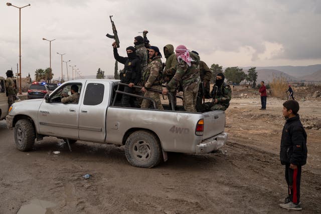 Members of the security forces of the newly formed Syrian government on a truck