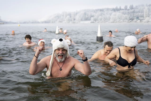 Swimmers attend the traditional New Year’s Eve swimming at lake Moossee in Moosseedorf, Switzerland