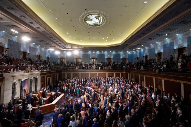 Members bow their heads during the opening prayer as the House of Representatives meets to elect a speaker and convene the new 119th Congress at the Capitol in Washington