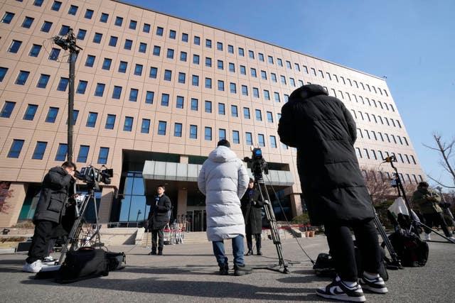 Media members wait for the arrival of impeached South Korean President Yoon Suk Yeol near the Corruption Investigation Office for High-ranking Officials in Gwacheon