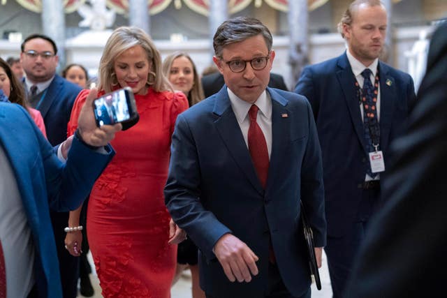 Speaker of the House Mike Johnson, accompanied by his wife Kelly Johnson, walks to the House Chamber before starting the 119th United States Congress at the Capitol in Washington