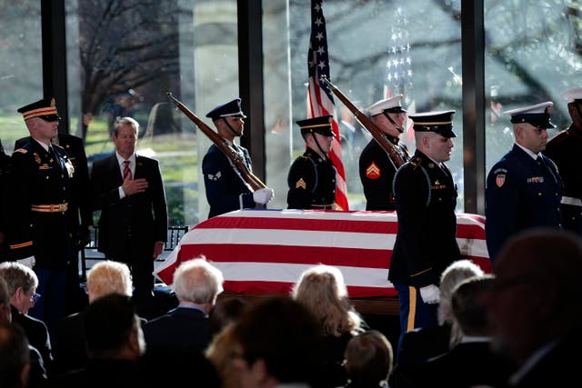 A military body bearer team places the flag-draped coffin of former US president Jimmy Carter on to the catafalque at the Jimmy Carter Presidential Library and Museum in Atlanta 