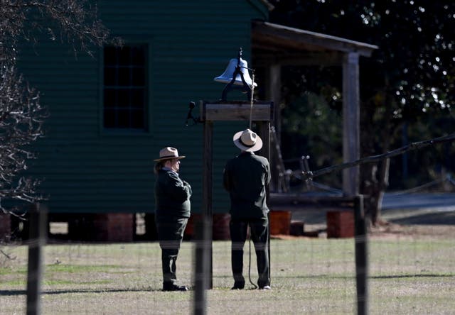 Karen Barry, left, and Randy Dillard ring the farm bell 