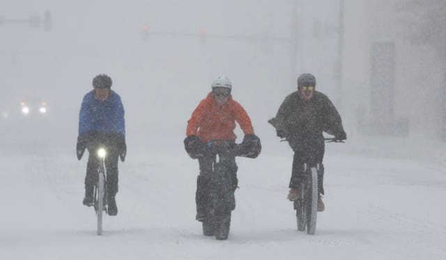 A group of cyclists make way through downtown Wichita