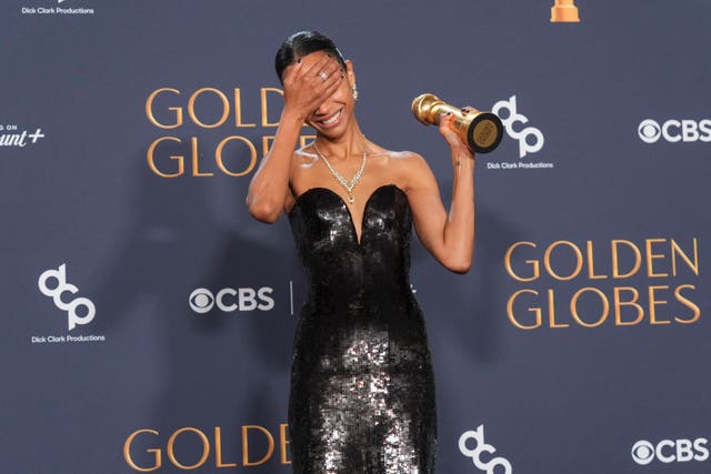 Zoe Saldana poses with her award