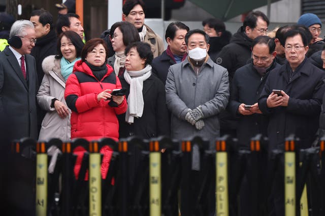 Members of the ruling People Power Party wait for the arrival of investigators from the Corruption Investigation Office for High-ranking Officials