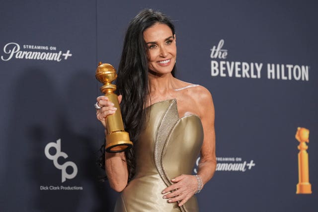 Demi Moore poses in the press room with the award for best performance by a female actor in a motion picture