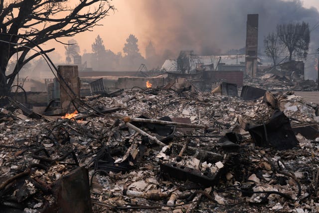 The Palisades Fire ravages a neighborhood amid high winds in the Pacific Palisades neighborhood of Los Angeles