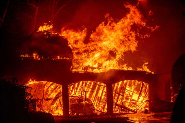 The Eaton Fire burns a residence in Altadena, California